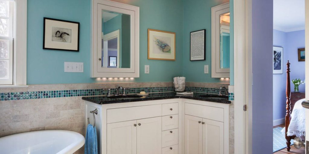 a-white-cabinet-in-a-light-green-color-bathroom-corner