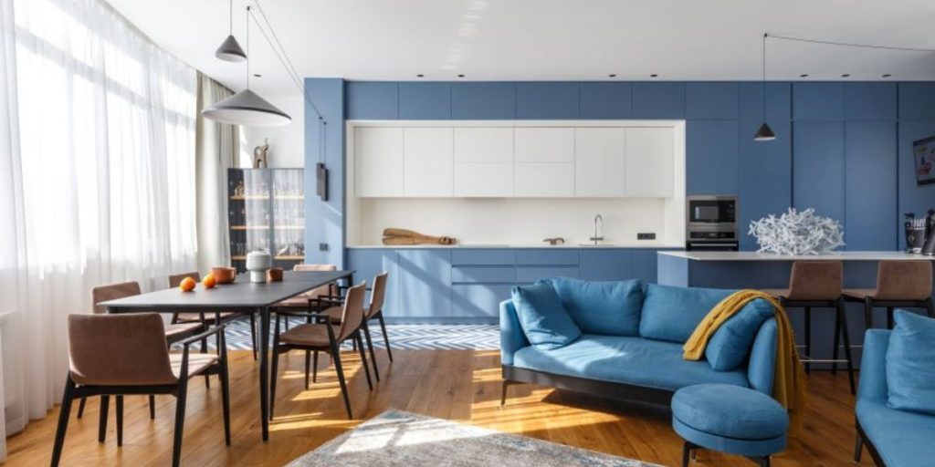 Kitchen with closet with sleepy blue doors and sofa with footstool
